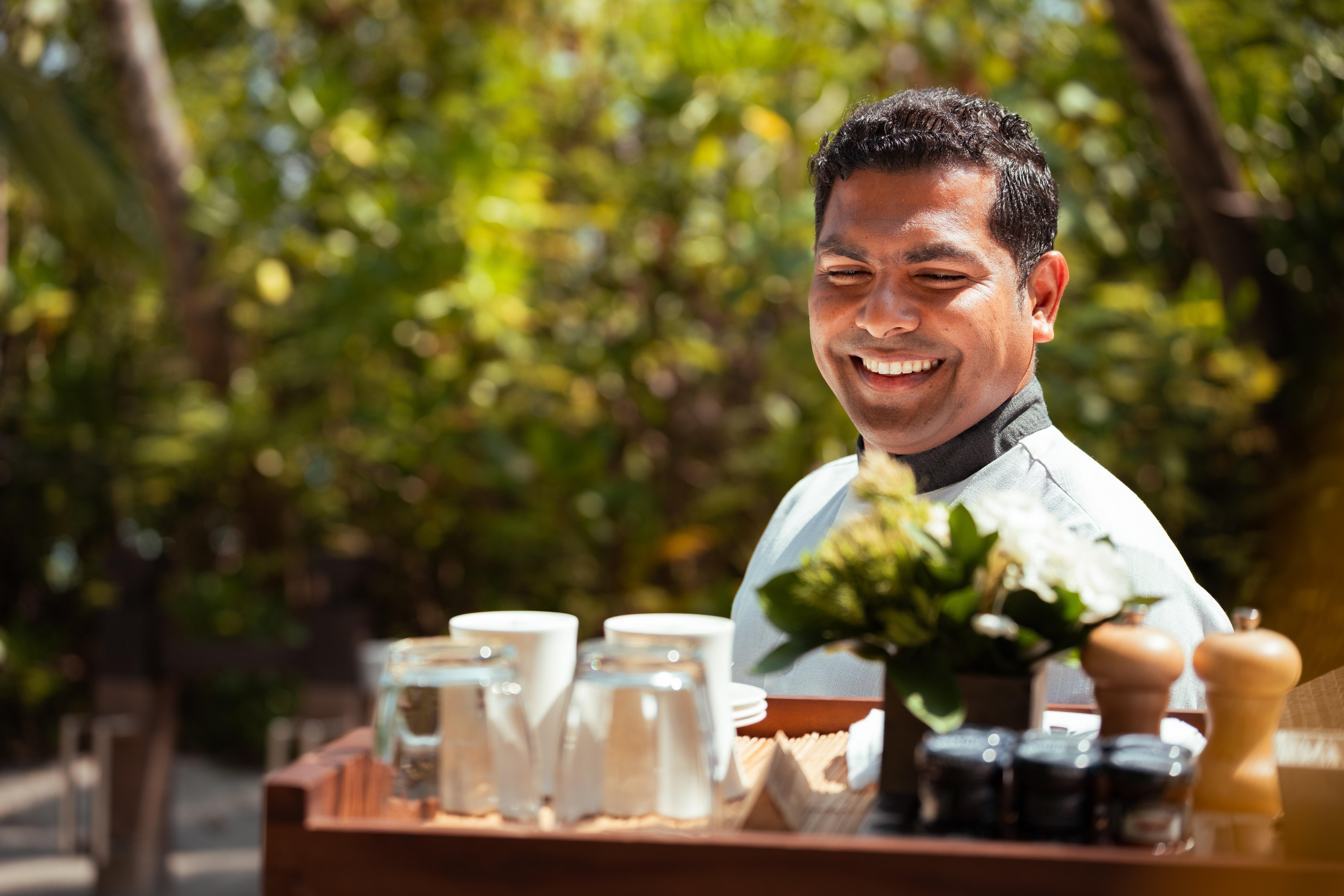 Male resort staff holding tray