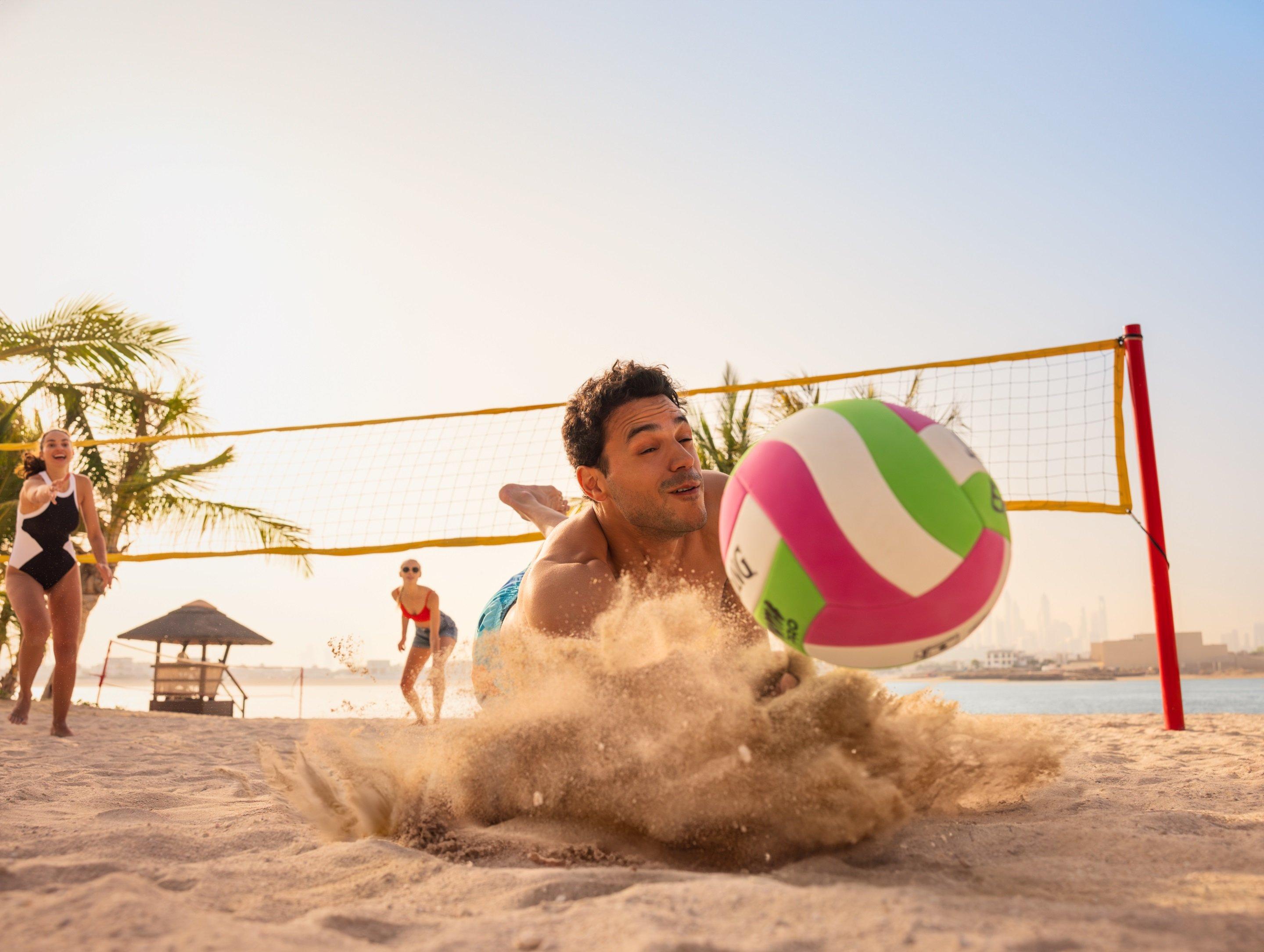Man playing Volley ball on Beach