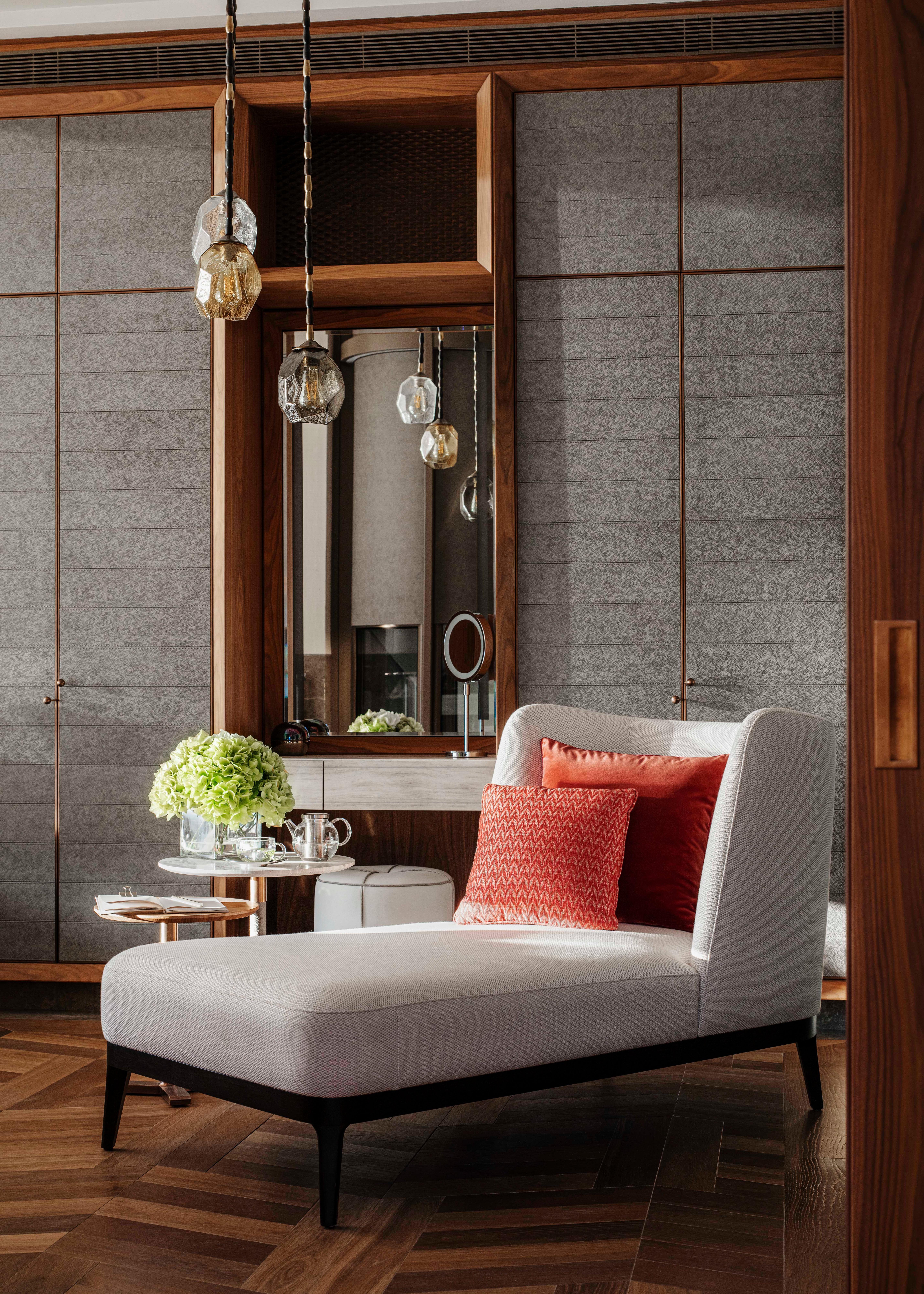 Luxury room seating area with chaise lounge and vanity at One&Only Portonovi