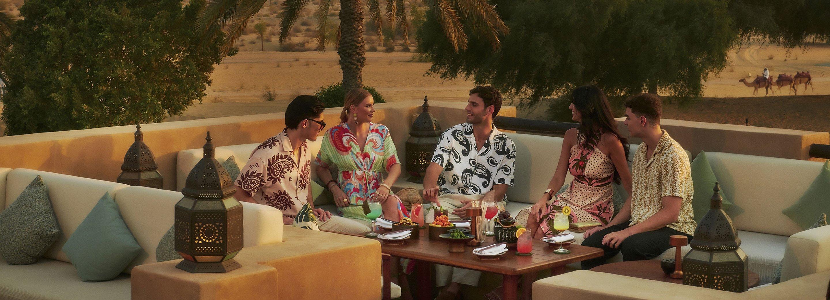 Friends enjoying luxurious dining at Bab Al Shams, Dubai
