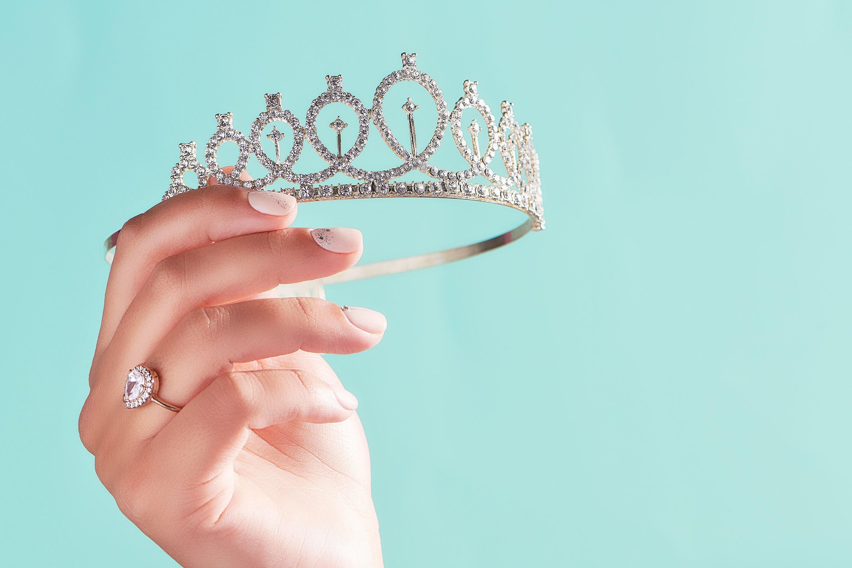 Hand holding crown